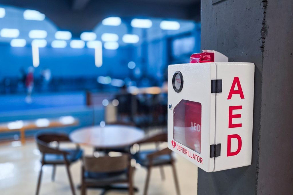 AED or Automated External Defibrillator installed on wall in Sports Gym as first aid in heart attack emergency situation.